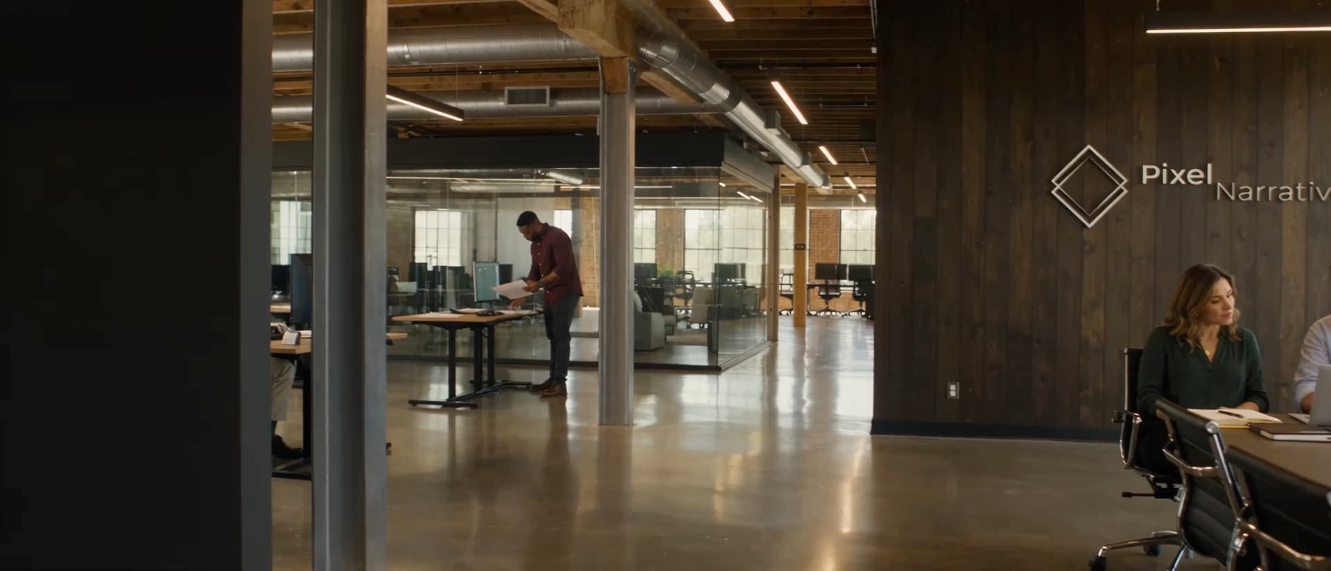 The Pixel Narratives studio, with the company mark on a wood-paneled wall
